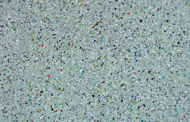 Textura de superfíci de cimento com pequenos pedaços de vidros de cores diferentes