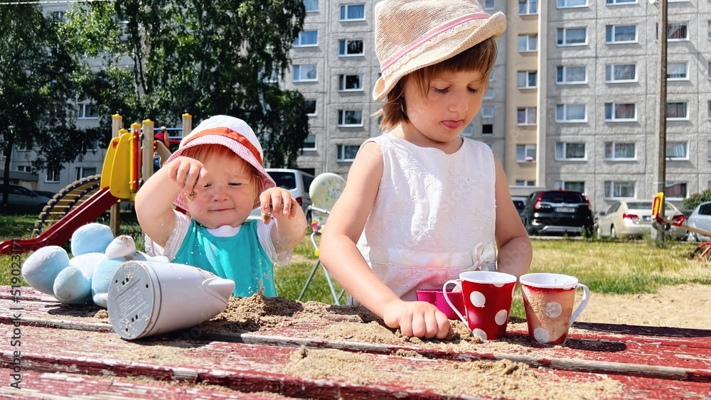 Poster two girls playing at playground at backyard of blocks of flats