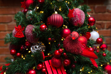 Christmas tree dressed up for Christmas and New Year's Eve. All the Christmas decorations are red.