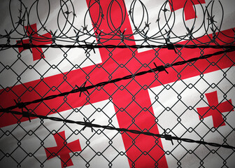 Georgia flag behind barbed wire and metal fence