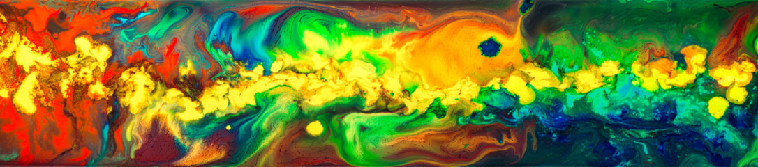 Ink and paint mixing and swirling in a rainbow of colors. Colorful abstract background.