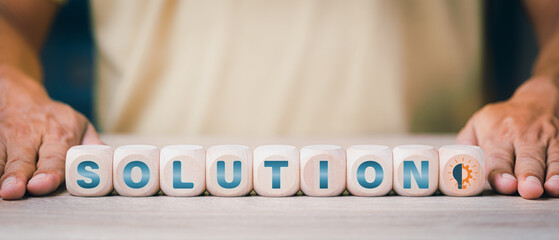 a businessman showing a wooden block with the word solution,Ideas and strategies to advise and connect creativity, inspiration,Brainstorming for effective goals, solving problems together