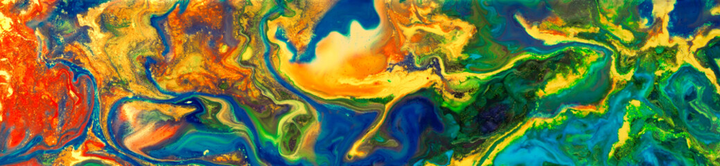 Ink and paint mixing and swirling in a rainbow of colors. Colorful abstract background.