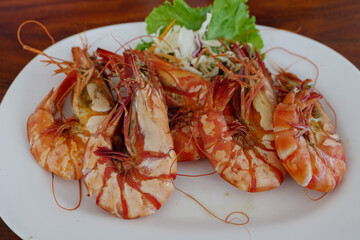 Heap of boiled prawn serve on white plate dish.
