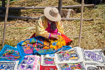 Traditional woman weaving fabrics on Floating islands Titicaca lake, Peru