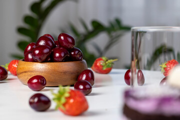 sweet berries of ripe red cherries during meals