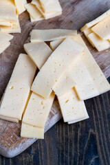 cut into pieces real hard cheese with lots of milk