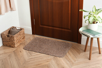 Clean door mat on wooden floor in hall - obrazy, fototapety, plakaty