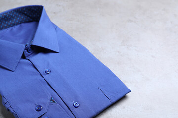 Stylish blue shirt on grey background. Dry-cleaning service