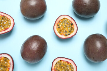 Fresh ripe passion fruits (maracuyas) on light blue background, flat lay
