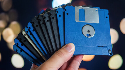 Lot of old floppy disks in men hand