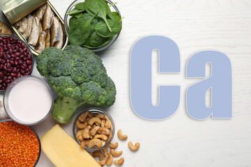 Different fresh products with high amounts of easily absorbable calcium on white wooden table, flat lay
