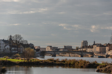 autumn in old european city with cathedral and river