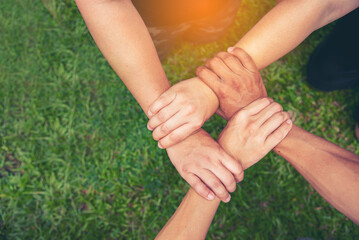 Top View Four hands Diverse multiethnic Partner team together. Close up Teamwork group of Four multiracial people join hands together. Above view Diversity people hand join partner team trust team