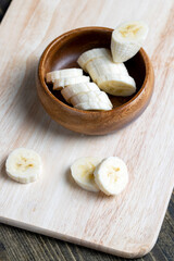 sliced ripe banana on a wooden board, close up