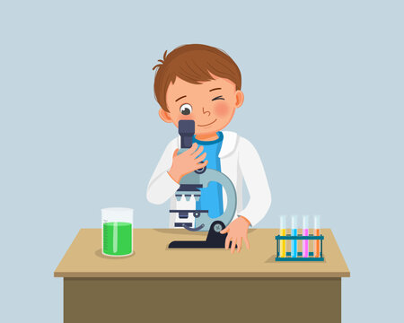 cute little boy scientist looking through microscope doing research with chemical fluid in science project experiment in the laboratory