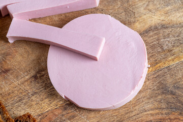 sliced boiled sausage on a wooden board