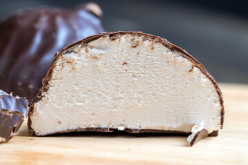 white creamy marshmallows in milk chocolate, close up