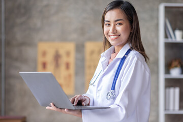 Portrait of a beautiful Youn Asian female doctor sitting in medical office