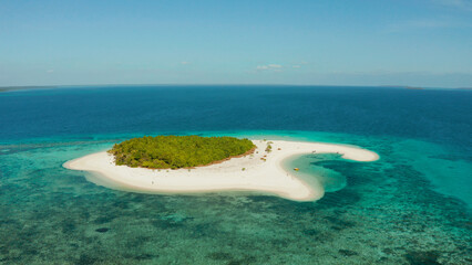 Tropical island with sandy beach by atoll with coral reef and blue sea, aerial view. Patawan island...