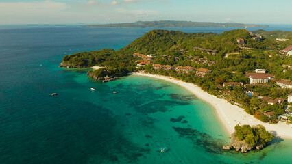 White sandy beach with tourists and hotels in Boracay Island, Philippines, aerial view. Seascape with beach on tropical island. Summer and travel vacation concept.