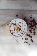 Disposable coffee on a table full of coffee grains