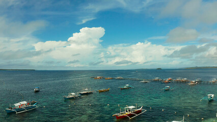 Obraz premium Tourist boats moored to a long pier on a tropical island, General Luna, Siargao.