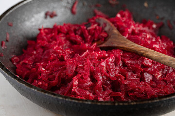 grated beets in frying pan