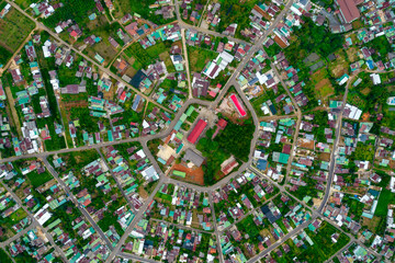 Residential area in Bao Loc city, Vietnam seen from above with the center being the church and the...