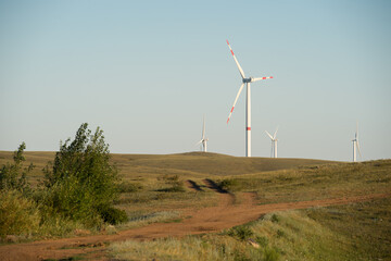 Fototapeta premium Landscape with wind turbines generating electricity for a small town.