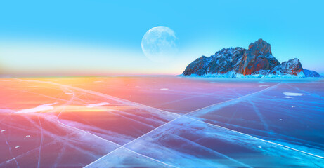 Ogoy island on winter Baikal lake with transparent cracked blue ice with full moon at sunrise - Baikal, Siberia, Russia  "Elements of this image furnished by NASA"