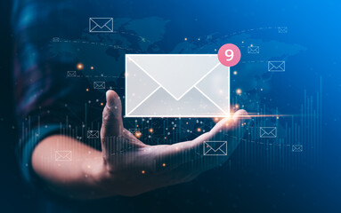 email marketing concept. businessman hand holding envelope or email icon global digital business...