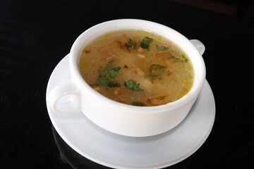 delicious and healthty chicken soup in a white bowl