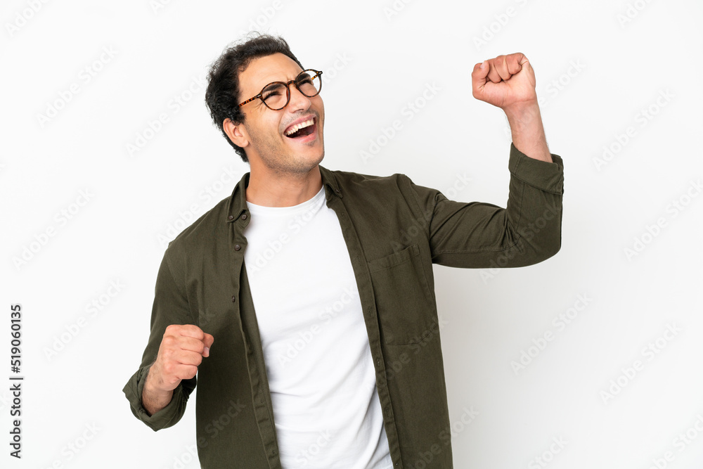 Wall mural Caucasian handsome man over isolated white background celebrating a victory