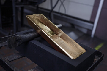 Pure gold ingot in the mold.