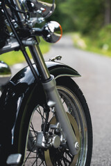 The front wheel of a motorcycle. Close up brakes and spokes