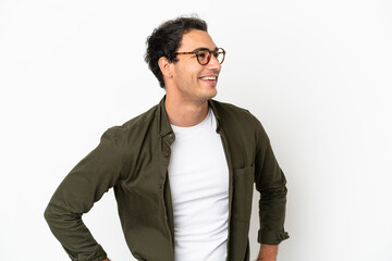 Caucasian handsome man over isolated white background posing with arms at hip and smiling