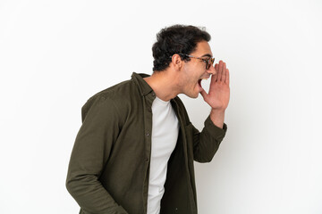 Caucasian handsome man over isolated white background shouting with mouth wide open to the side