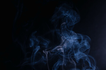 frankincense with white smoke on black background