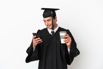 Young university graduate over isolated white background holding coffee to take away and a mobile