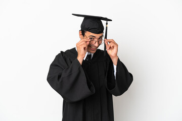 Young university graduate over isolated white background with glasses and surprised