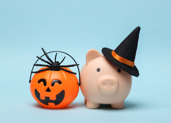 Halloween piggy bank with witch hat and jack lantern candy bucket on blue background. Trick or Treat