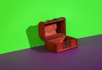 Empty pirate chest on green purple background