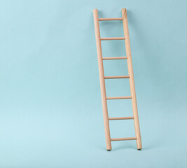 Wooden ladder on blue background. Minimum layout. Business, leadership concept, career growth