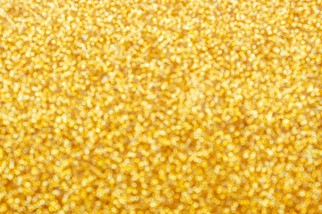 Gold light shiny bokeh abstract blur background with bright round defocus golden pattern.