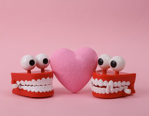 Two Funny lovers clockwork jumping teeth with heart on pink background. Valentine's day, love concept
