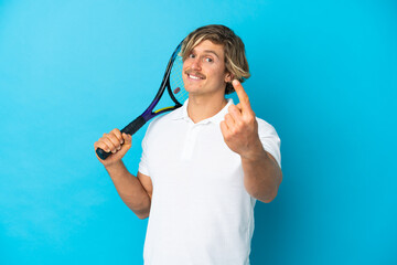 blonde tennis player man isolated on blue background doing coming gesture