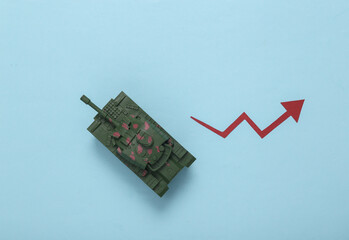 Fototapeta na wymiar Toy tank with growth arrow on blue background