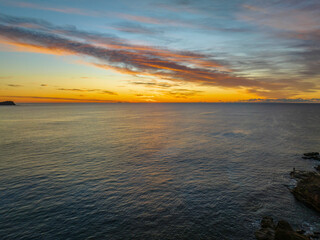 Sunrise over the sea with high cloud