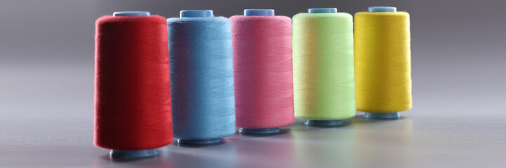 Fabric threads of different colors on gray background